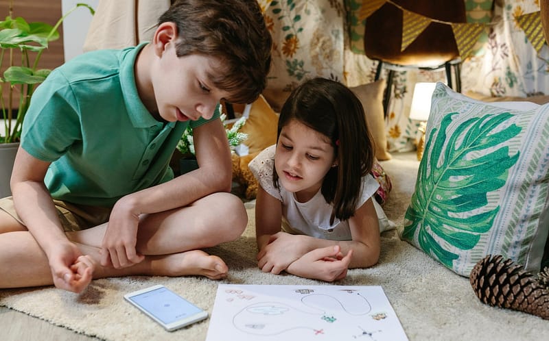 brothers-playing-treasure-hunting-game-in-a-diy-tent-at-home