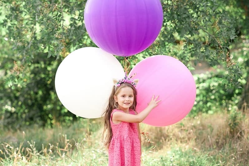 funny-baby-girl-4-5-year-old-holding-colorful-ball-2022-11-17-16-14-23-utc