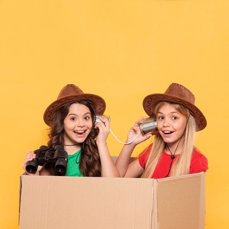 little-girl-with-hat-playing-in-cartoon-box